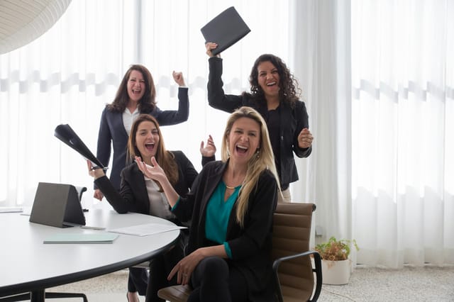 Group of cheerful employees celebrating a success